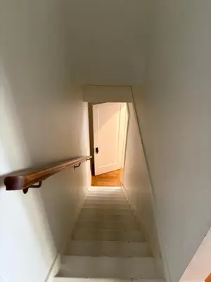 a stairway with a white door and a white staircase at Charming Victoria Character Home-Pet Friendly in Victoria