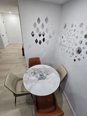 a dining room with a white table and chairs at Cozy Modern Spacious 2 Bedroom and full kitchen in Southwest Calgary in Calgary