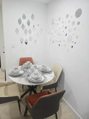 a table with chairs and plates and cups on it at Cozy Modern Spacious 2 Bedroom and full kitchen in Southwest Calgary in Calgary