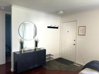 a room with a mirror and a dresser and a door at Falcon Escape in Calgary