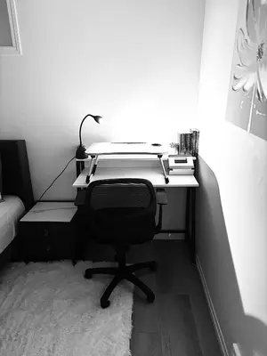 a desk with a chair in a bedroom at Chezeey Home in Edmonton