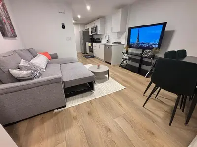 a living room with a couch and a flat screen tv at Chezeey Home in Edmonton