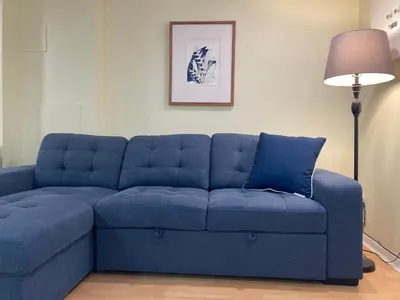 a blue couch in a living room with a lamp at Private Suite in Vancouver in Vancouver