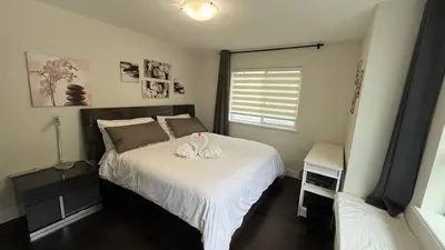 a bedroom with a bed with a stuffed animal on it at Carrie's The Gentle Nest No 2 in Coquitlam