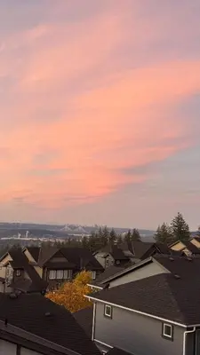 a view of roofs of houses at sunset at Carrie's The Gentle Nest No 2 in Coquitlam