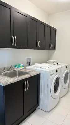 a kitchen with a washing machine and a sink at Carrie's The Gentle Nest No 2 in Coquitlam