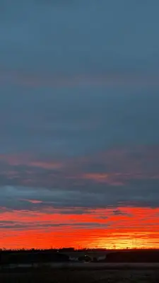 a sunset with a blue and red sky at Entire Home - backyard oasis, indoor fireplace, Huge TV in Fort McMurray