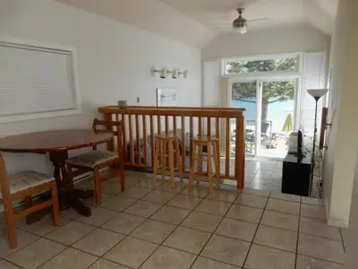 a kitchen with a table and chairs and a table and a dining room at Beach front cabin near Nelson, BC in Nelson