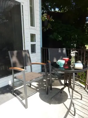 a table and two chairs on a patio at Beach front cabin near Nelson, BC in Nelson