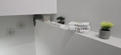 a shelf with plants and boxes on a wall at Glacier Comfort Living Suite in Calgary