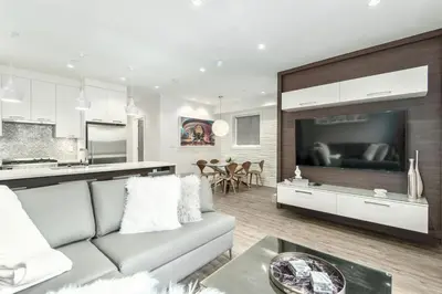 a living room with a couch and a large television at Kitsilano Retreat at Private 3 Bed with Parking and BBQ in Vancouver