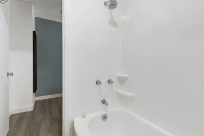 a bathroom with a white tub and a sink at Gateway Suites Private Double room Near Canmore and Banff in Canmore
