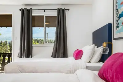 two beds in a bedroom with a window at Gateway Suites Private Double room near Banff in Canmore