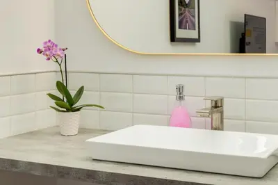 a white sink in a bathroom with a mirror at Gateway Suites Rocky Mountains Private Double room close to Banff in Canmore