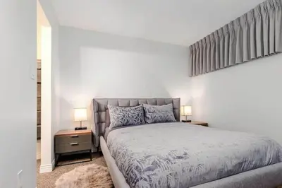 a bedroom with a large bed and two night stands at Whistler Village Retreat, Private Hot Tub & Sauna in Whistler