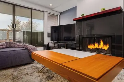 a living room with a fireplace and a couch at Whistler Village Retreat, Private Hot Tub & Sauna in Whistler