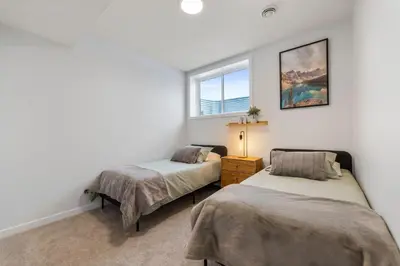 a bedroom with two beds and a window at Dont Overpay-2Bd 1 Bath -Calm Family Place in Calgary