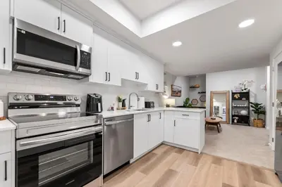 a kitchen with white cabinets and stainless steel appliances at Dont Overpay-2Bd 1 Bath -Calm Family Place in Calgary