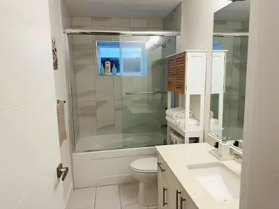 a bathroom with a shower and a toilet and sink at Cozy Dreamscape in Surrey