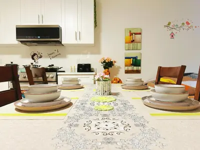 a table with plates and dishes on it in a kitchen at Cozy Dreamscape in Surrey