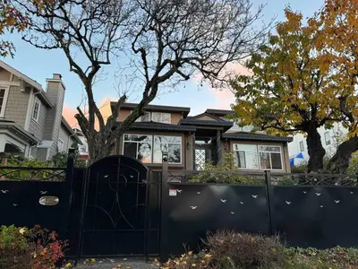 a black gate in front of a house at Adorable, 2 Bedrooms in West Vancouver in West Vancouver