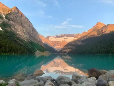 a view of a lake with mountains in the background at Chancellor Peak 1BR and Loft Wooden Cabin near Lake Louise in Golden