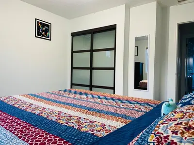 a bedroom with a bed with a quilt on it at A beautiful 2 bedroom private home in Hinton