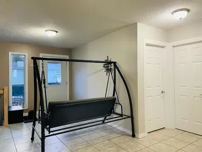 a room with a bench in the corner of a room at A beautiful 2 bedroom private home in Hinton