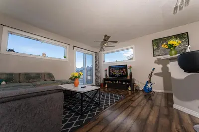 a living room with a couch and a table at A beautiful 2 bedroom private home in Hinton