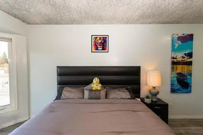 a bedroom with a bed with a stuffed animal on it at A beautiful 2 bedroom private home in Hinton