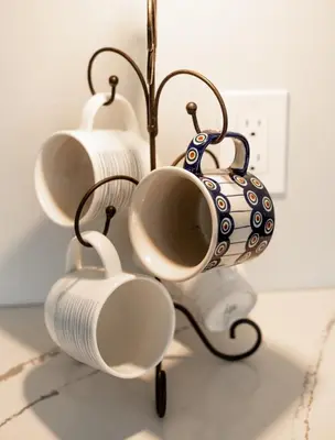 a group of cups and a vase on a rack at Pet friendly Family home in Shawnigan Lake in Shawnigan Lake