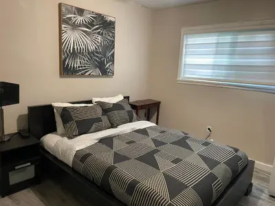 a bedroom with a bed and a window at Central Vally Private House in Abbotsford