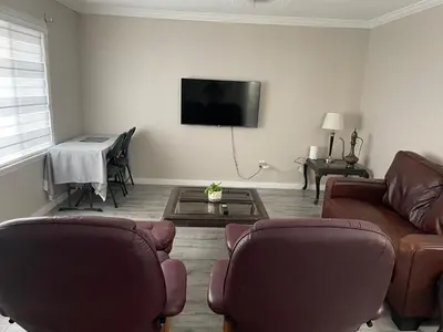 a living room with two couches and a flat screen tv at Central Vally Private House in Abbotsford