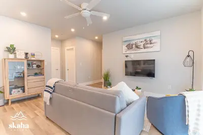 a living room with a couch and a ceiling fan at Skaha Suites in Penticton