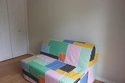 a colorful couch sitting in a living room at Home beside WEM in Edmonton