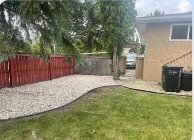 a backyard with a red fence and a driveway at Home beside WEM in Edmonton
