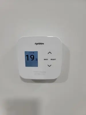 a digital clock on a white wall with the time at Cozy Suite near West Edmonton Mall in Edmonton
