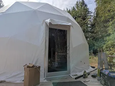 a large white tent with a door in it at Bela bahia in Qualicum Beach