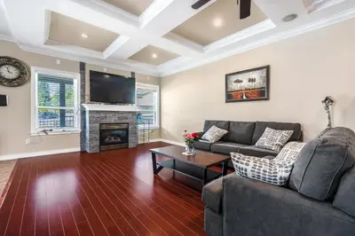 a living room with a couch and a fireplace at Coquitlam Heights Private Room in Coquitlam