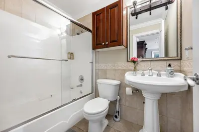 a bathroom with a sink and a toilet and a shower at Coquitlam Heights Private Room in Coquitlam
