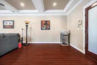 a living room with a couch and paintings on the wall at Coquitlam Heights Private Room in Coquitlam