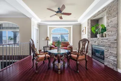 a living room with a table and chairs and a fireplace at Coquitlam Heights Private Room in Coquitlam
