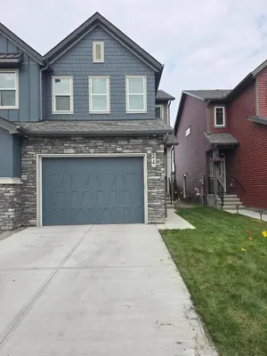 a house with a garage in the driveway at Peaceful Haven in Prime Location in Calgary