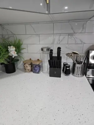 a kitchen counter with various kitchen utensils on it at Cozy Basement Suite, SW Calgary in Calgary