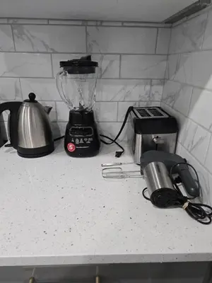 a kitchen counter with a blender and a toaster at Cozy Basement Suite, SW Calgary in Calgary