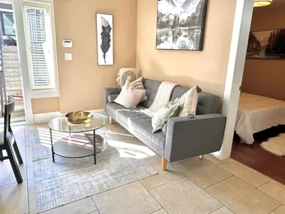 a living room with a couch and a table at Cozy 1 Bedroom Suite in Vancouver