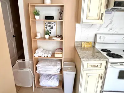 a small kitchen with a sink and a stove at Cozy 1 Bedroom Suite in Vancouver