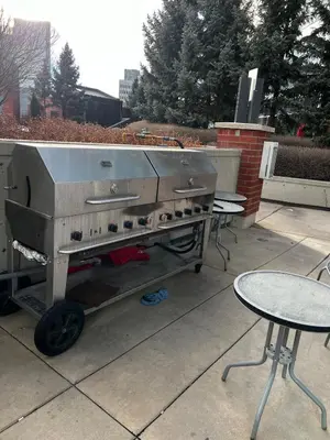 a barbecue grill sitting on a patio with a table at Calgary&Downtown&BMO Centre & Parking in Calgary