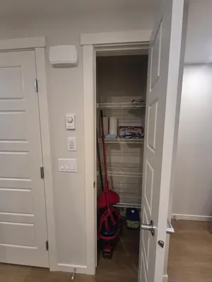 a closet with a red mop in a room at Superb 1-Bdr Apt in New Condo in Calgary