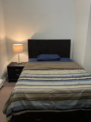 a bedroom with a bed and a lamp on a night stand at 3 Bed - Best View in Town! in Surrey
